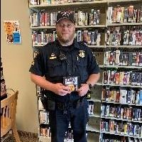A police officer holding an audiobook